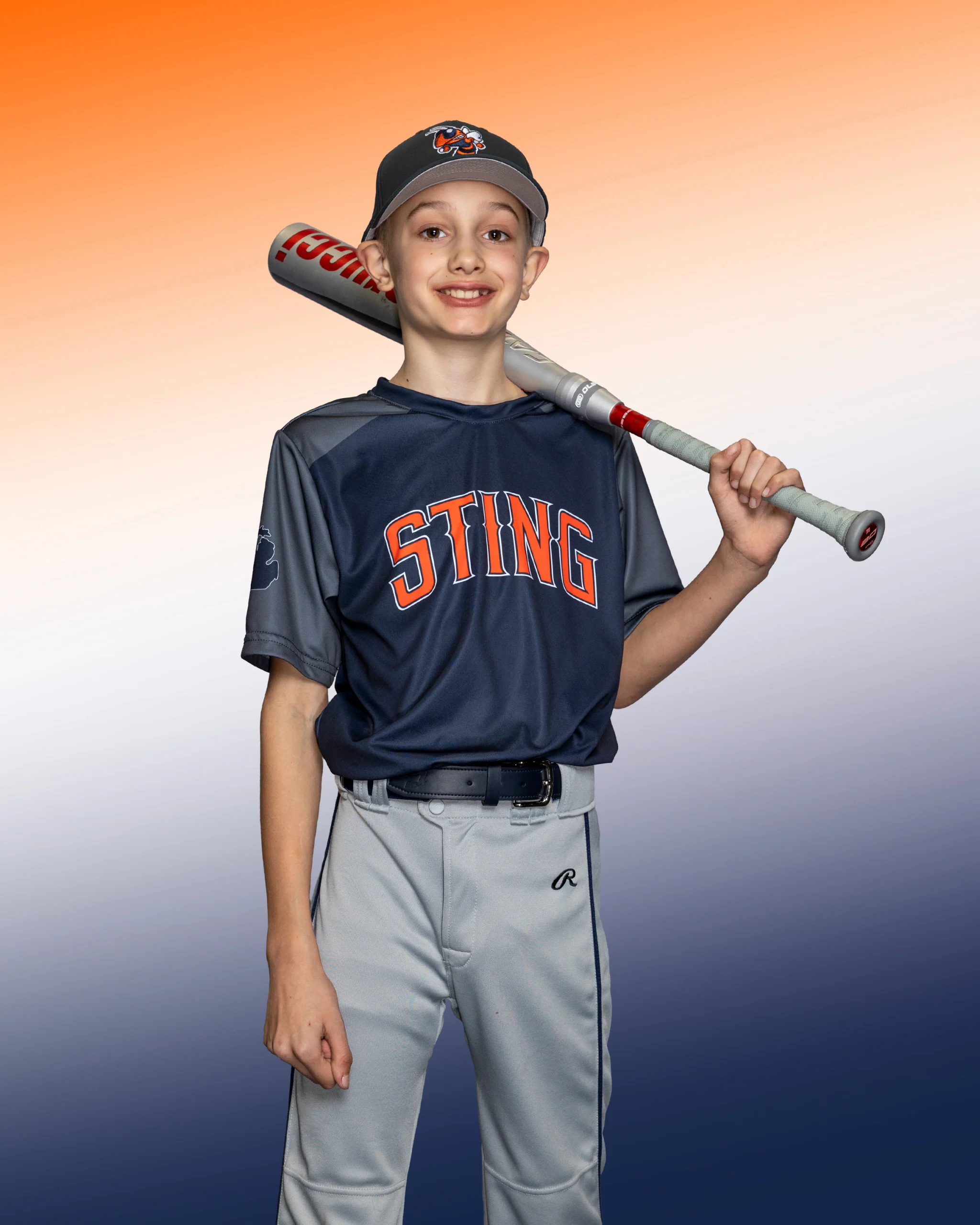 Brant Oberst in his Bloomfield Sting uniform, smiling with a bat